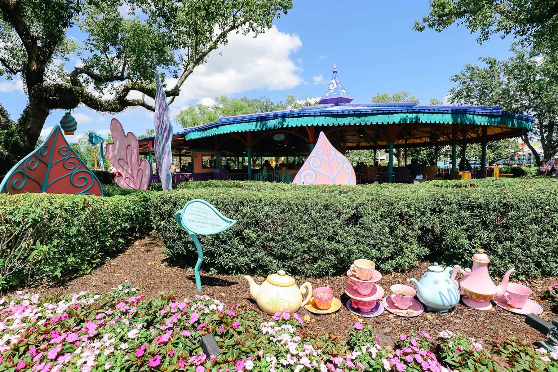 Stacks of teacups as theming outside the attraction. 