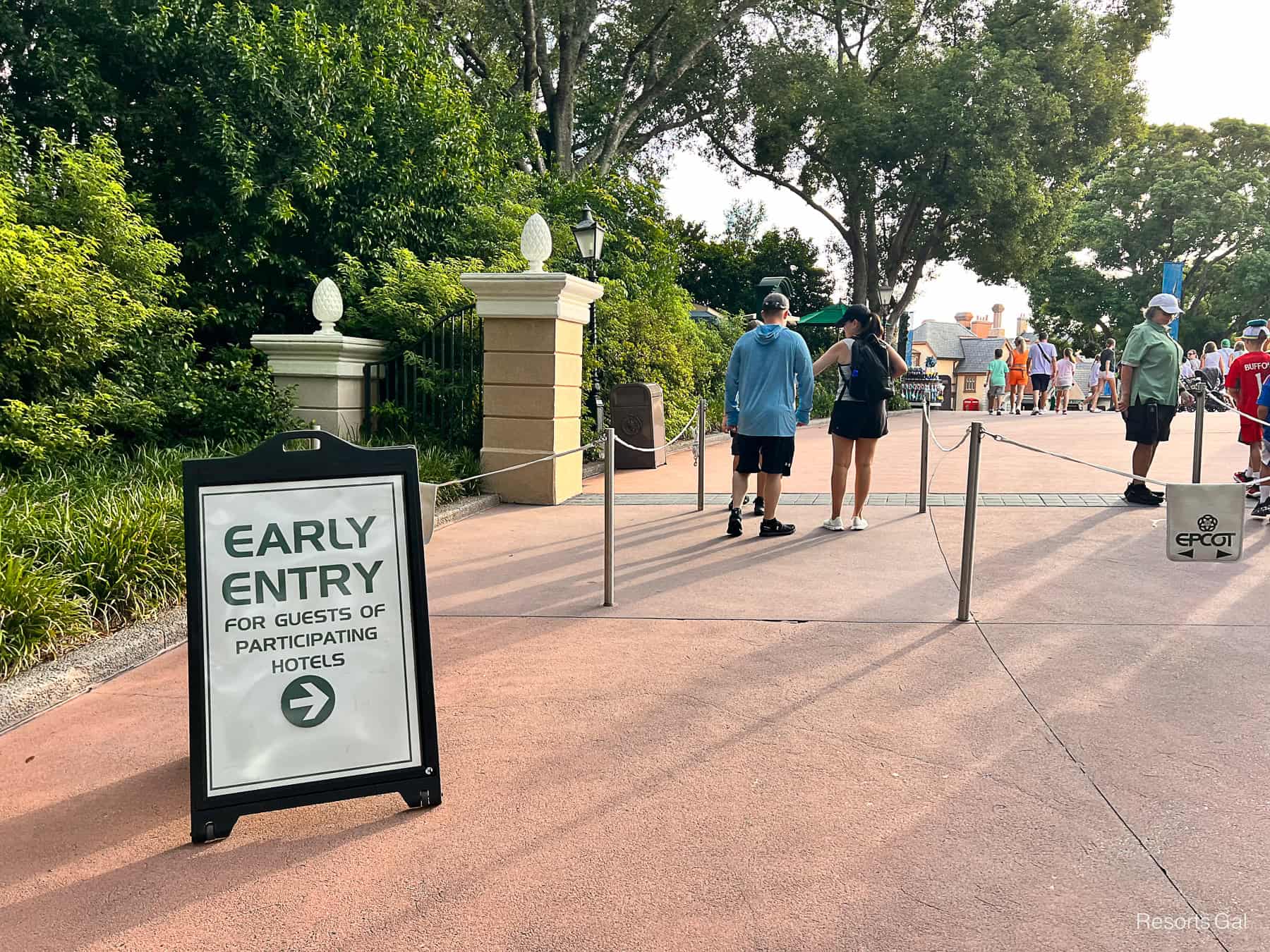 Cast member checking in guests for early entry at the International Gateway at Epcot 