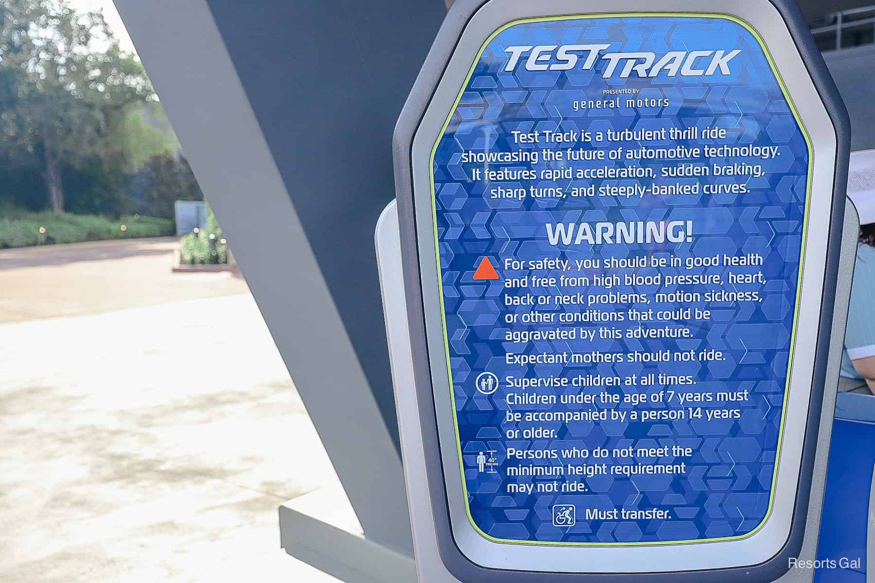 a sign that lists the ride warnings for Test Track outside of the attraction's entrance