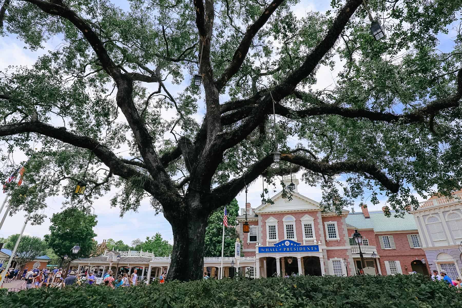 The Hall of Presidents at Magic Kingdom sits behind the Liberty Tree. 