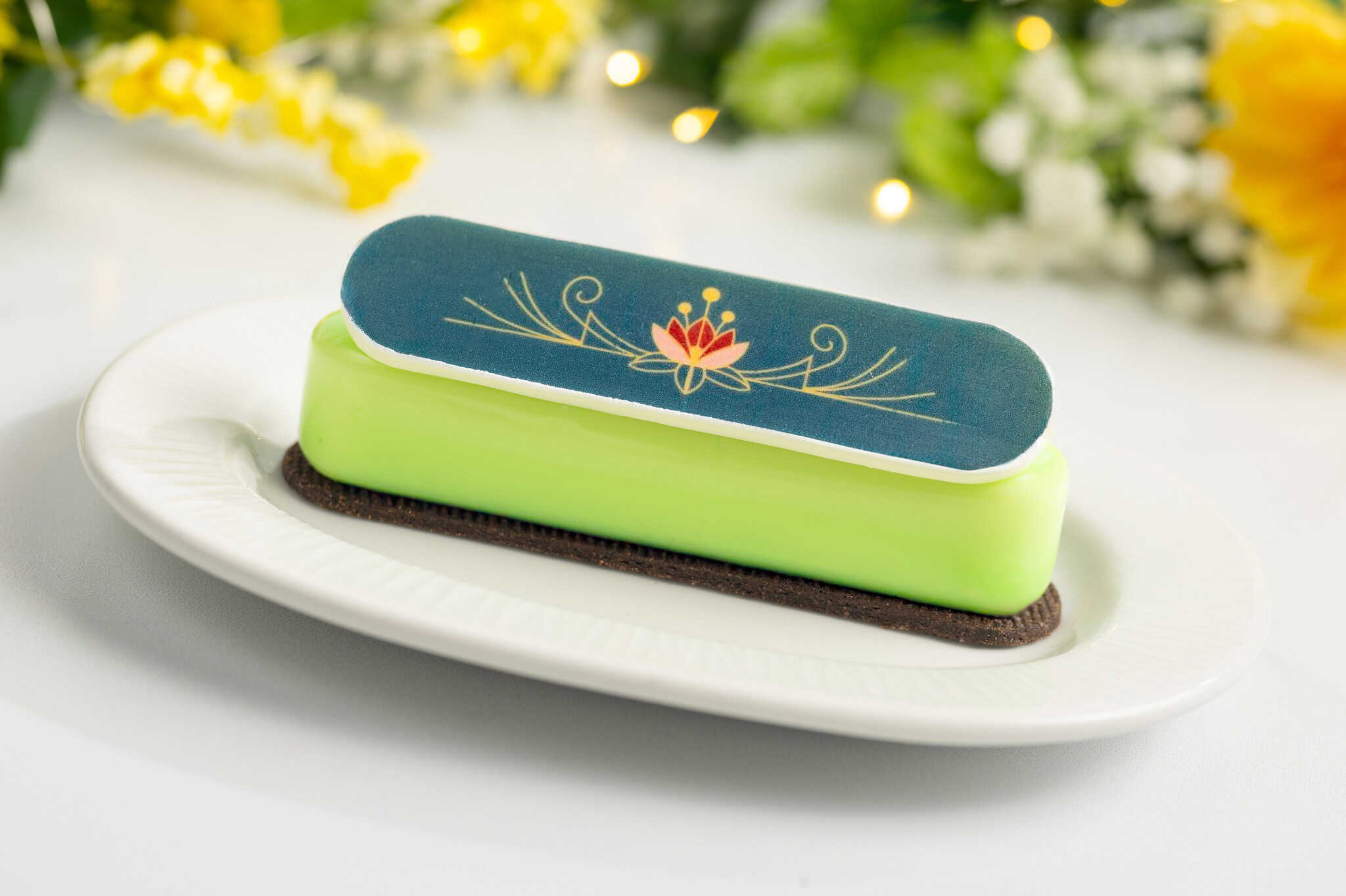 a green dessert bar with layers and decorative chocolate top 