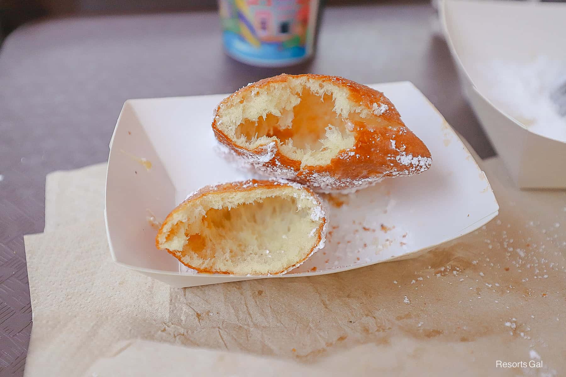 two beignets cut open with a hollow center