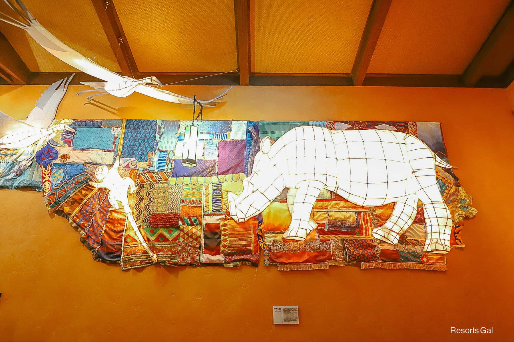 a piece of artwork with Rhinos and other animals shaped of lights 