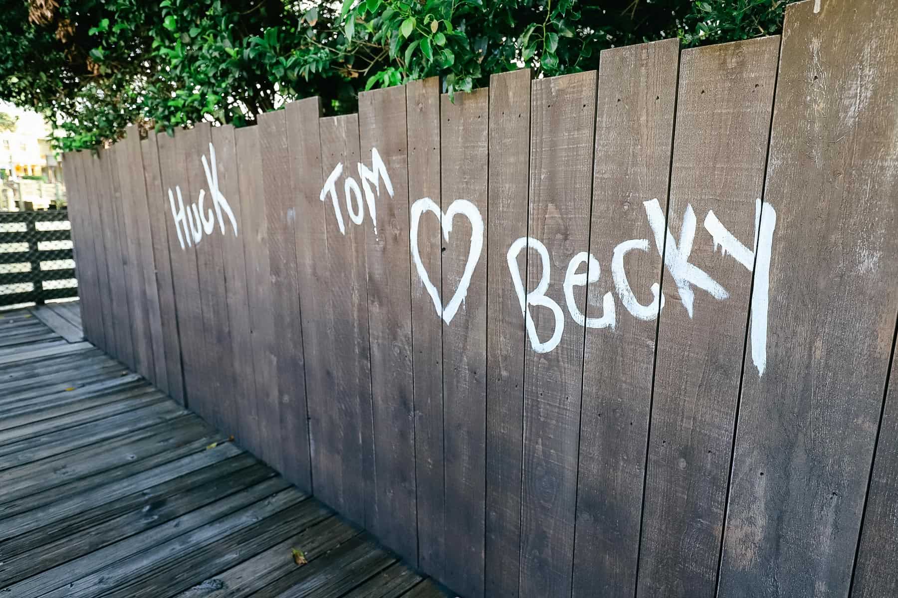 "Tom Loves Becky" painted on a fence 