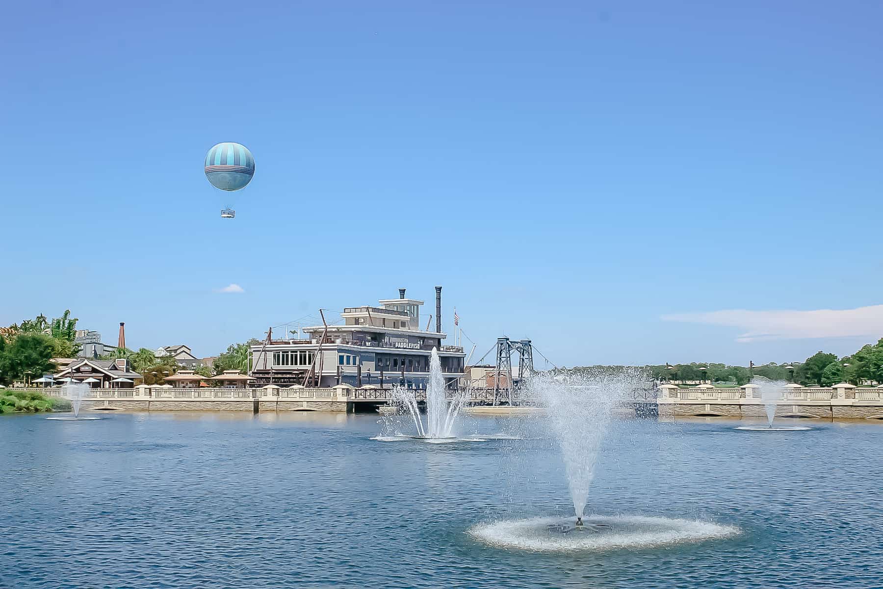 Disney Springs with the water and balloon in the background. 