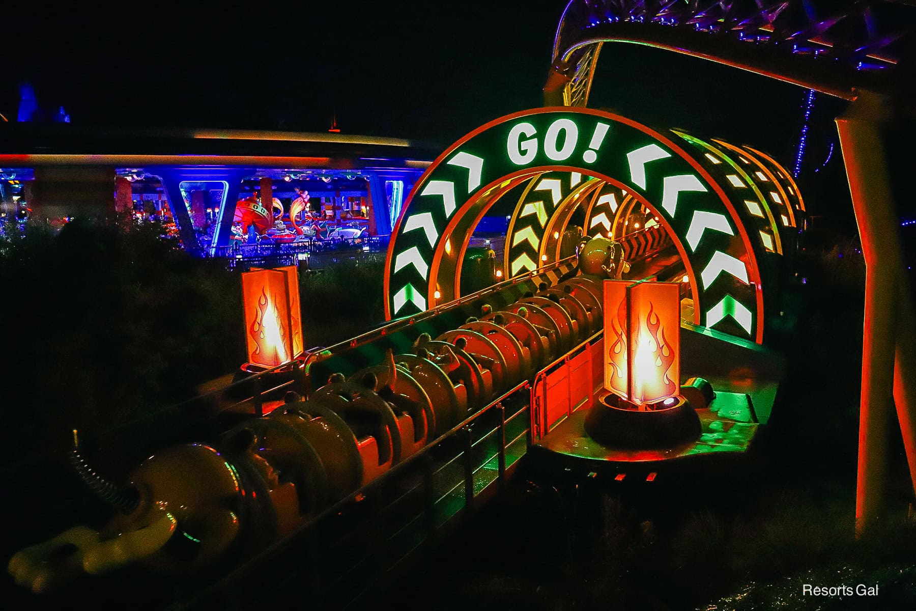 guests riding Slinky Dog Dash at night