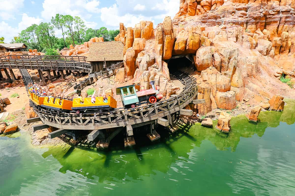 A train car races by on Big Thunder Mountain. 