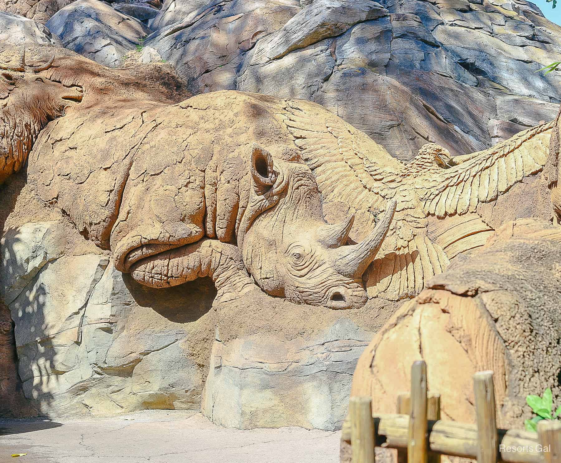 a rhinoceros wood carving at the base of the Tree of Life on Discovery Island 