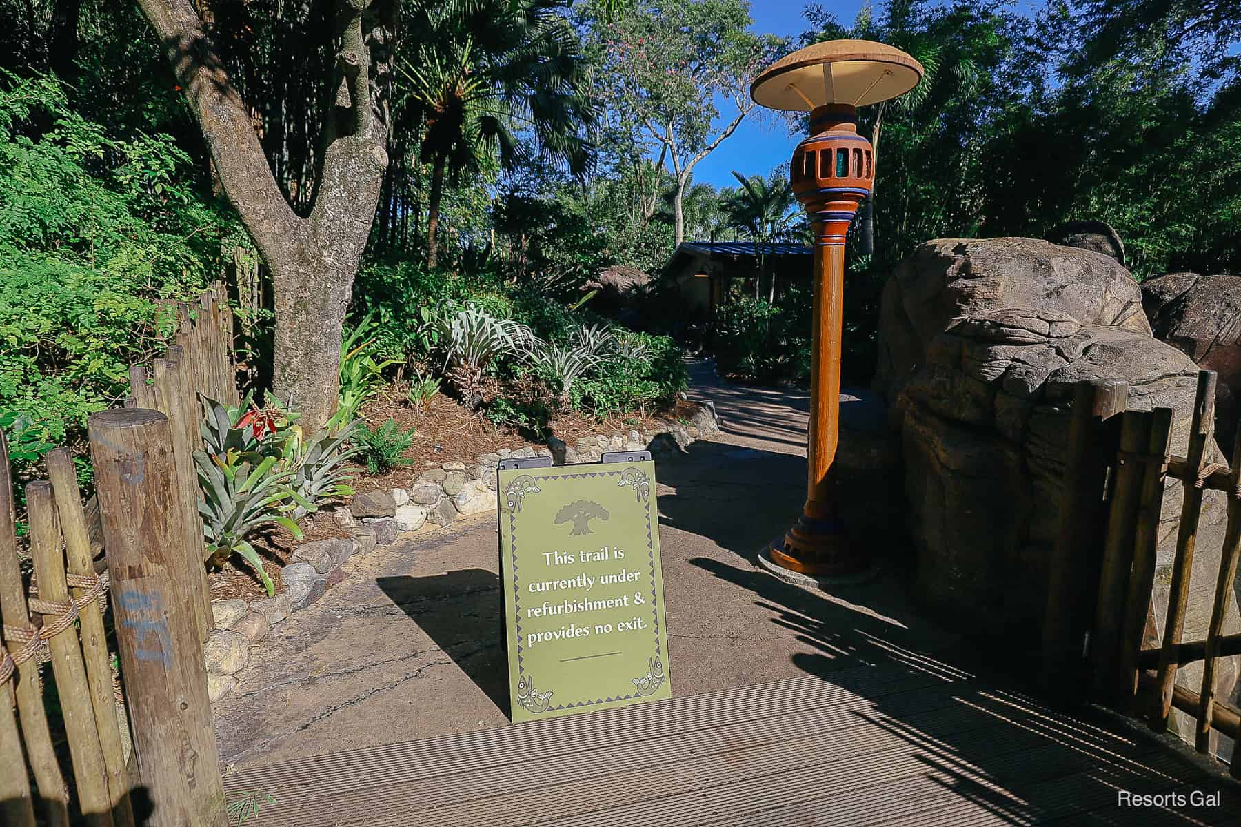 a sign that says the trail is currently under refurbishment and provides no exit 