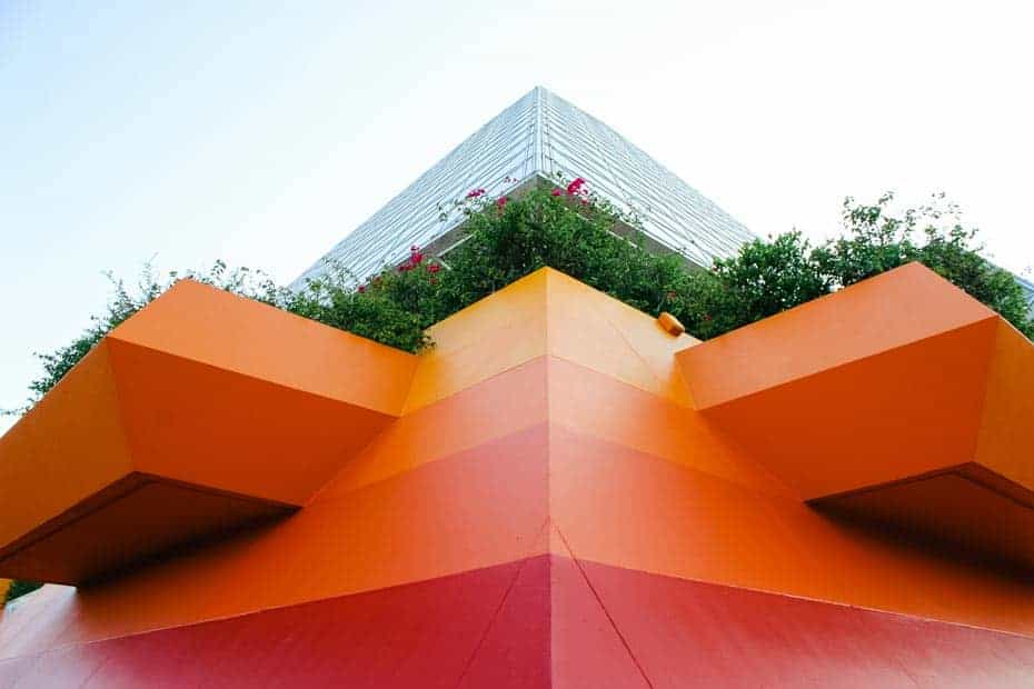 Red and shades of orange stripes on the triangular base of the Imagination Pavilion. 