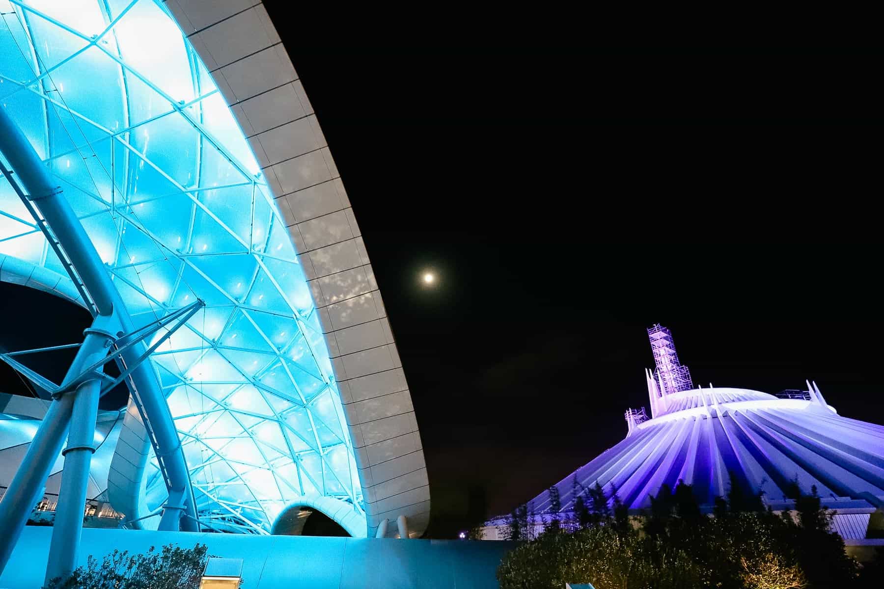 Tron sitting next to Space Mountain at night. 