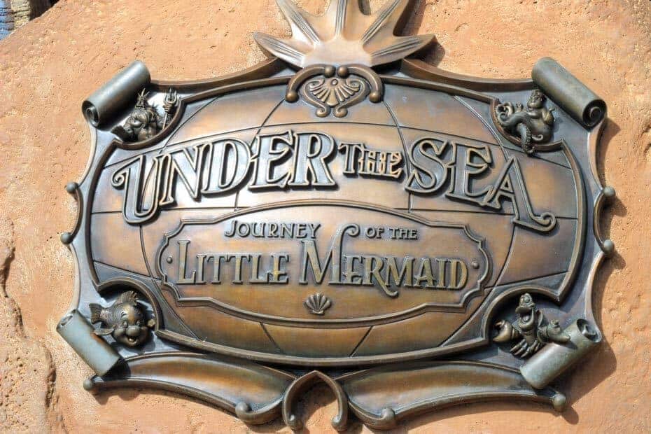 A plaque outside the ride that says Under the Sea, Journey of the Little Mermaid. 