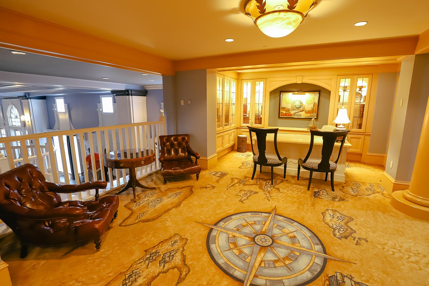 an upper level lobby with private sitting areas and a compass in the carpet at Disney's Yacht Club 
