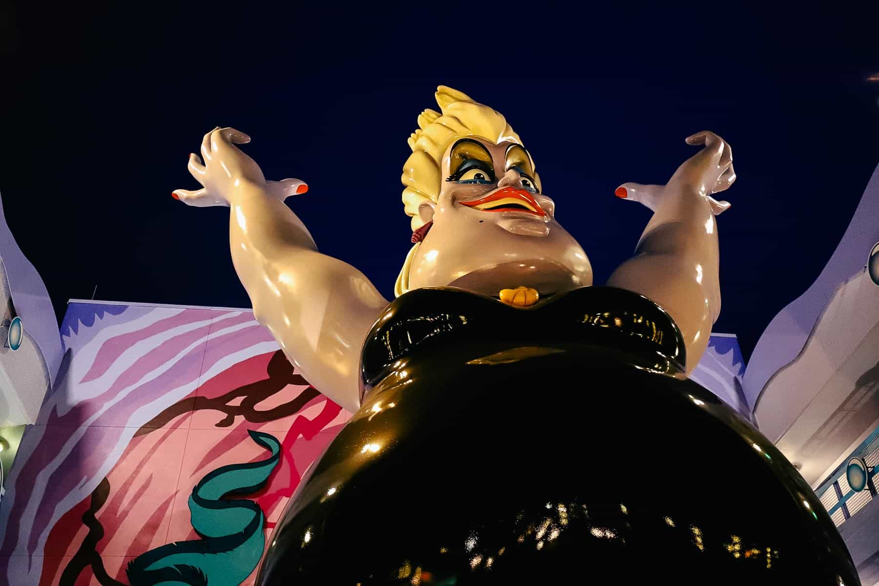 Ursula looks angry as she towers over the Art of Animation. 