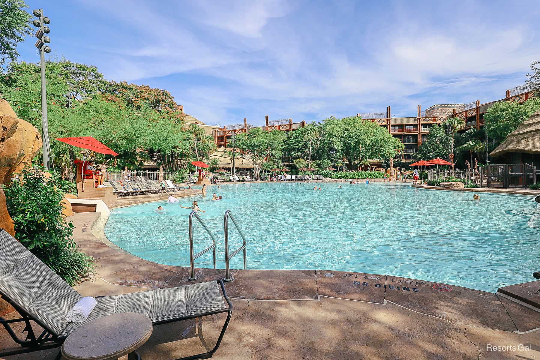 a view of the Uzima Springs Pool with a lounge chair and a rolled towel