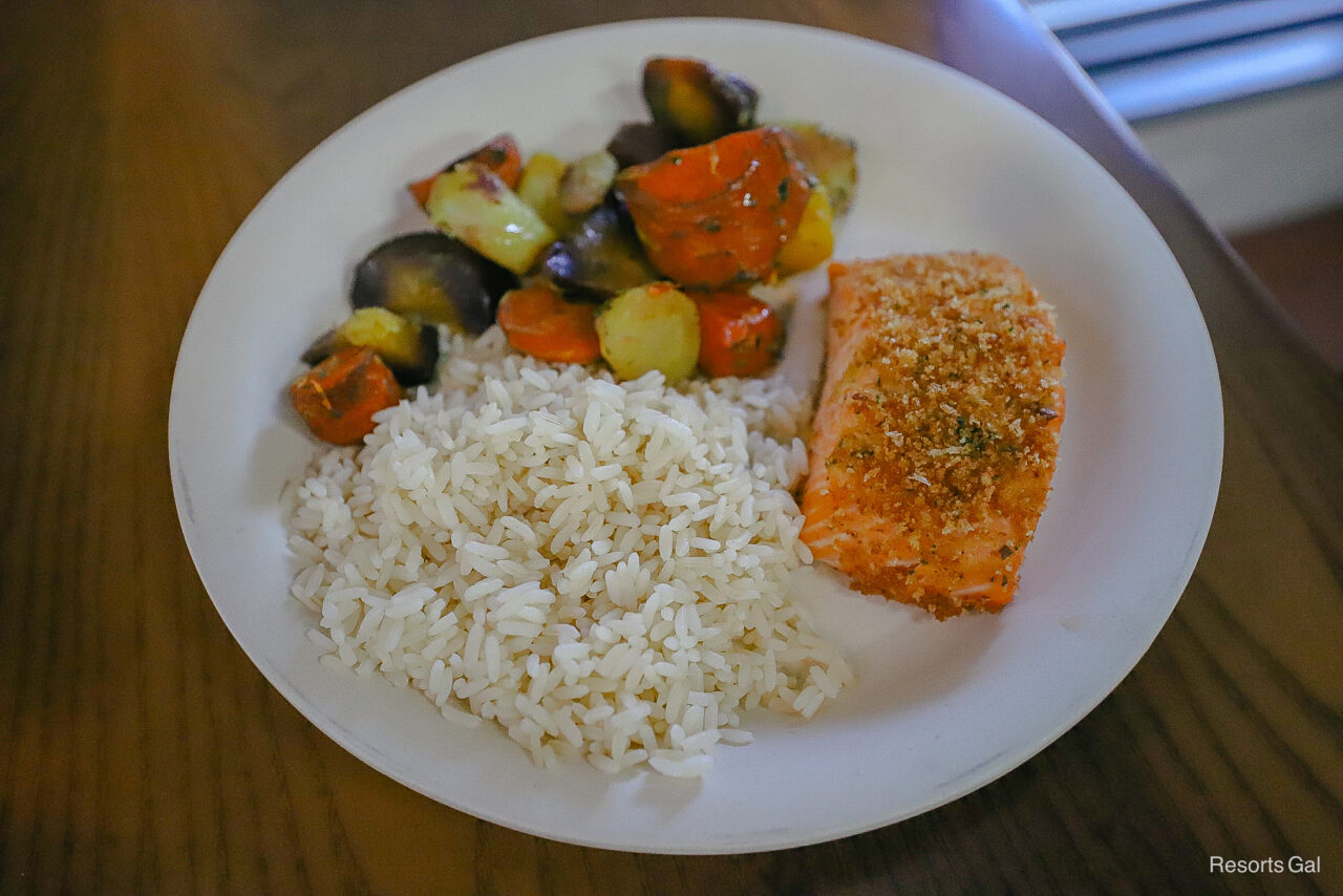 a platter of salmon with vegetables 