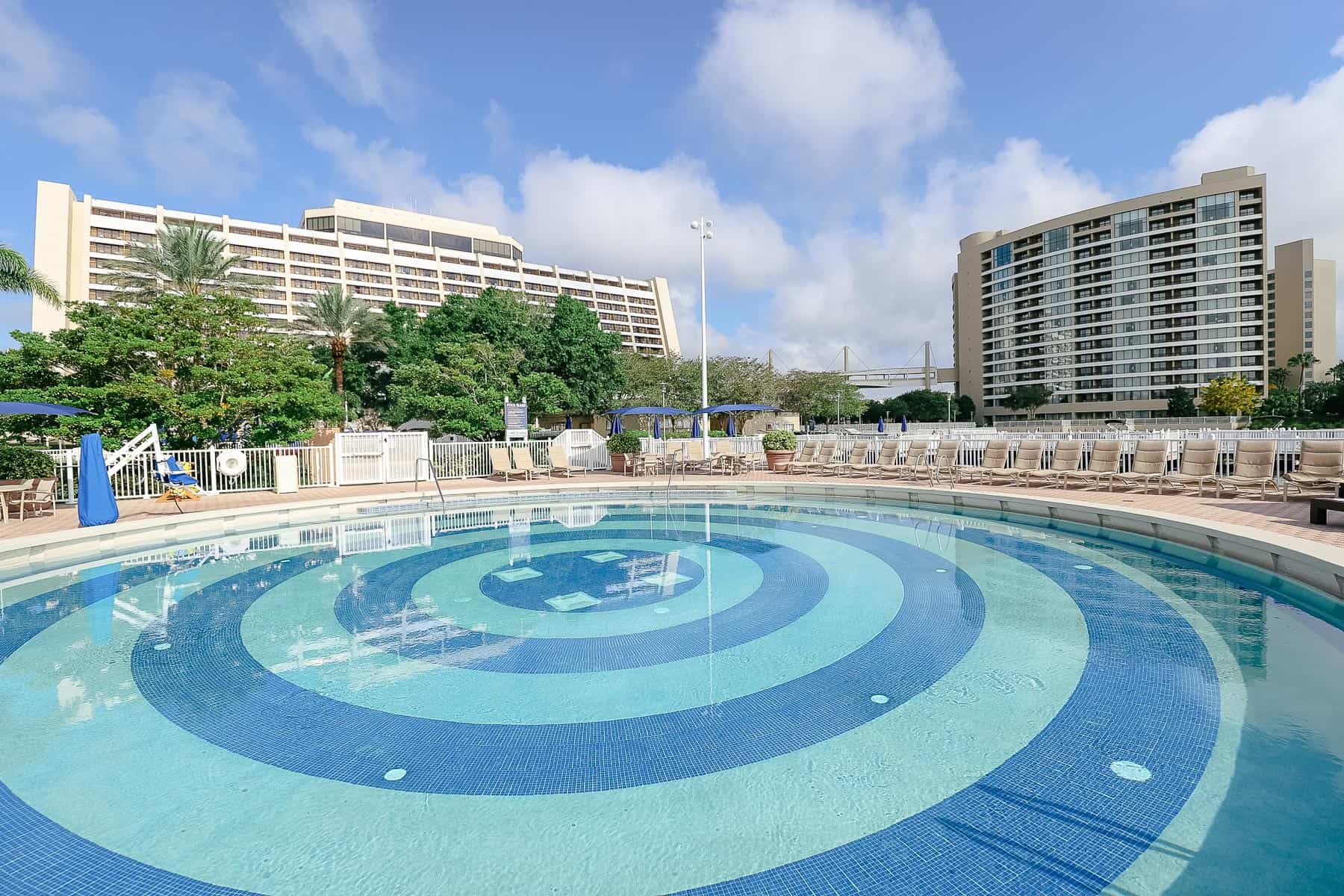 blue waters with mosaic tile in circles at the bottom of the pool 