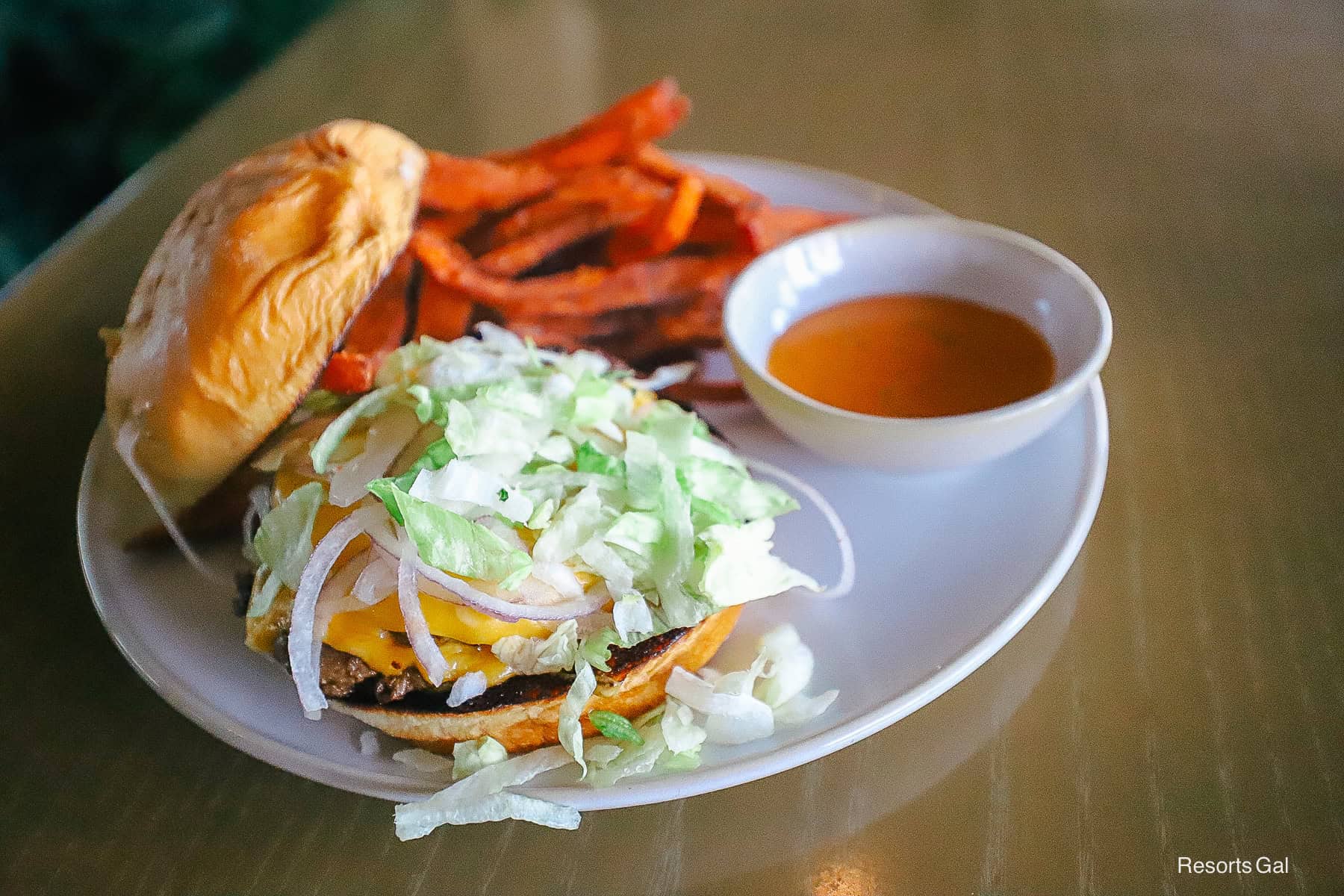 the bun removed from the burger so you can see the lettuce, onion, and cheese 