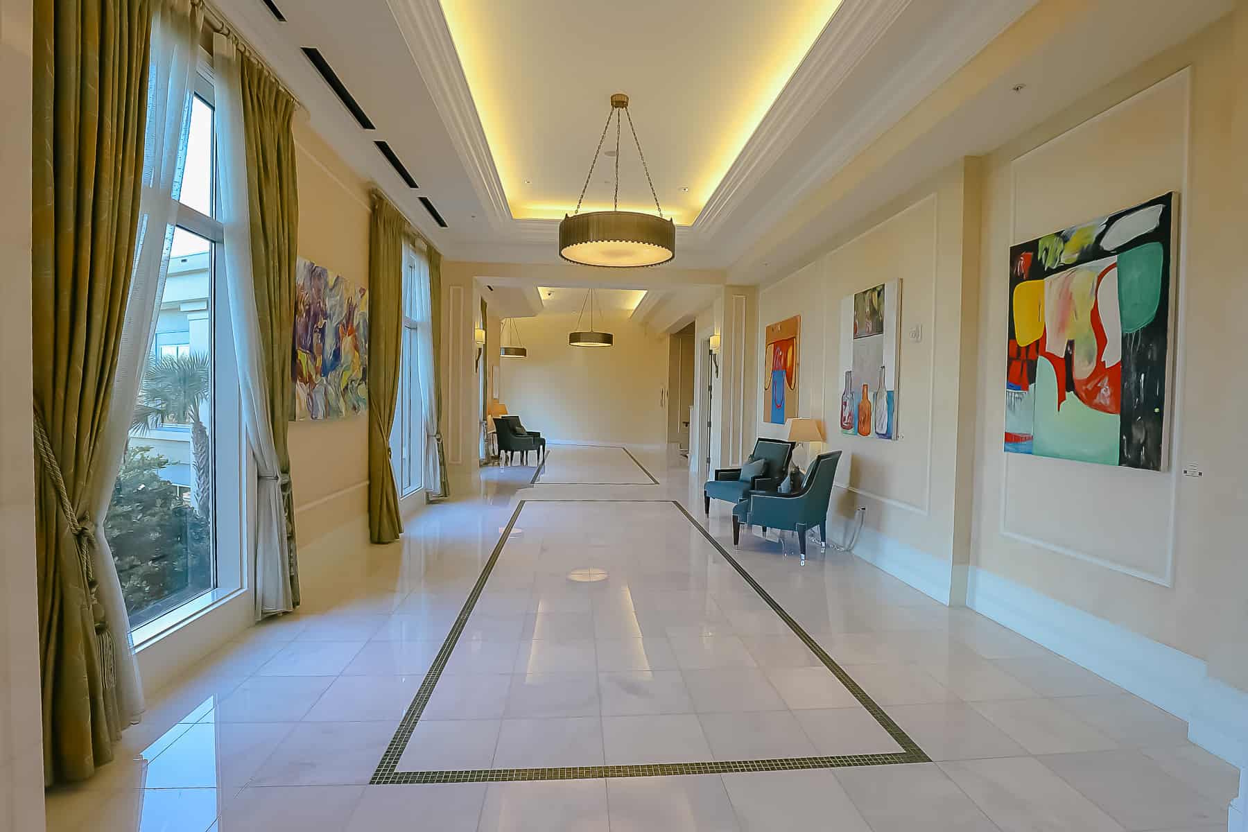 a marble tile hallway with artwork