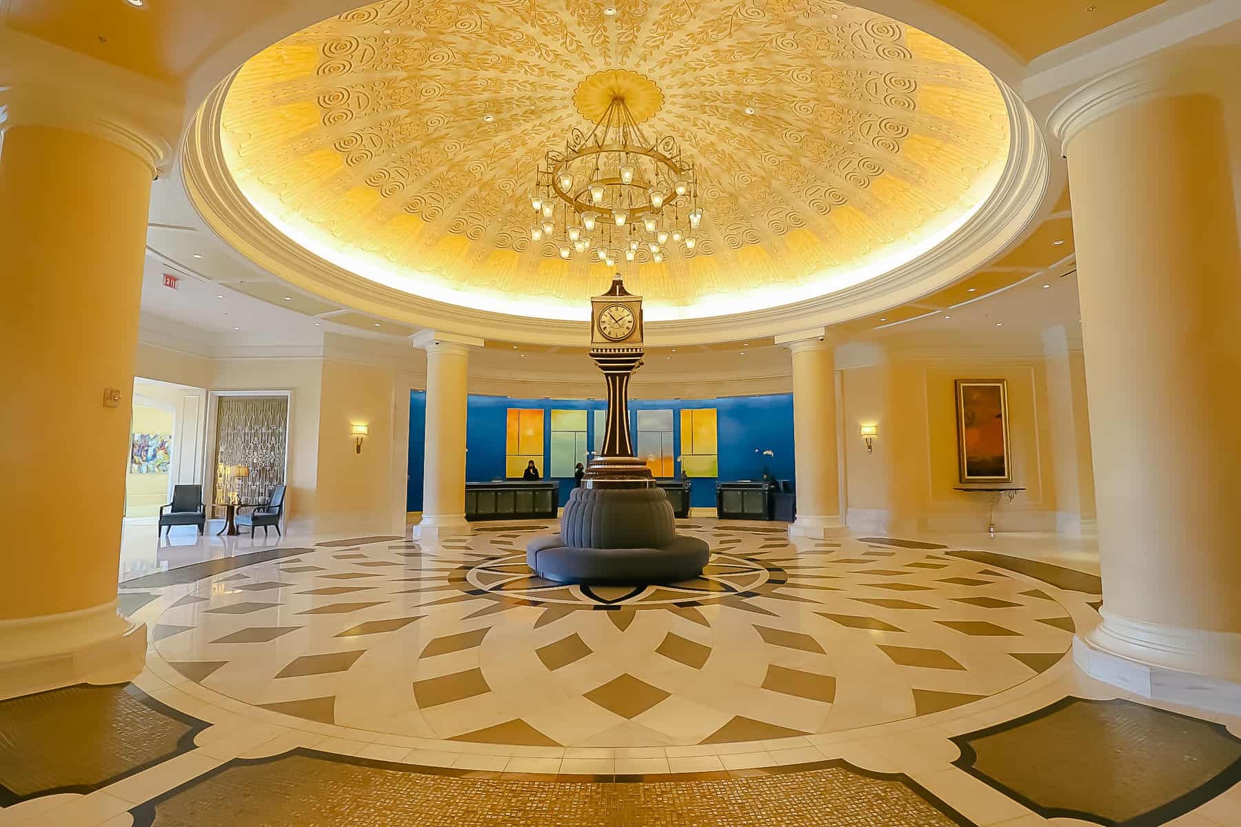 the grand reception area at the Waldorf Astoria Orlando with a stunning, chandelier, and clock underneath it 