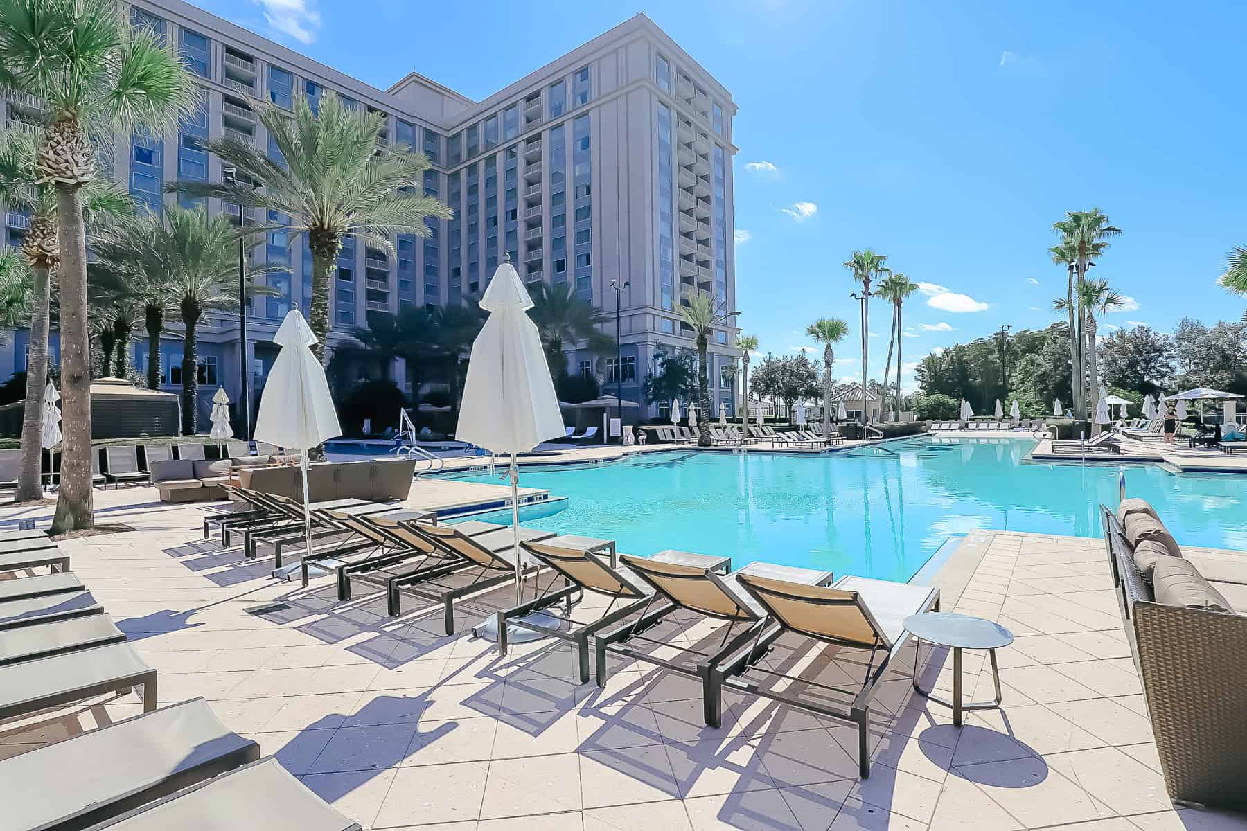 a line of lounge chairs facing the pool 