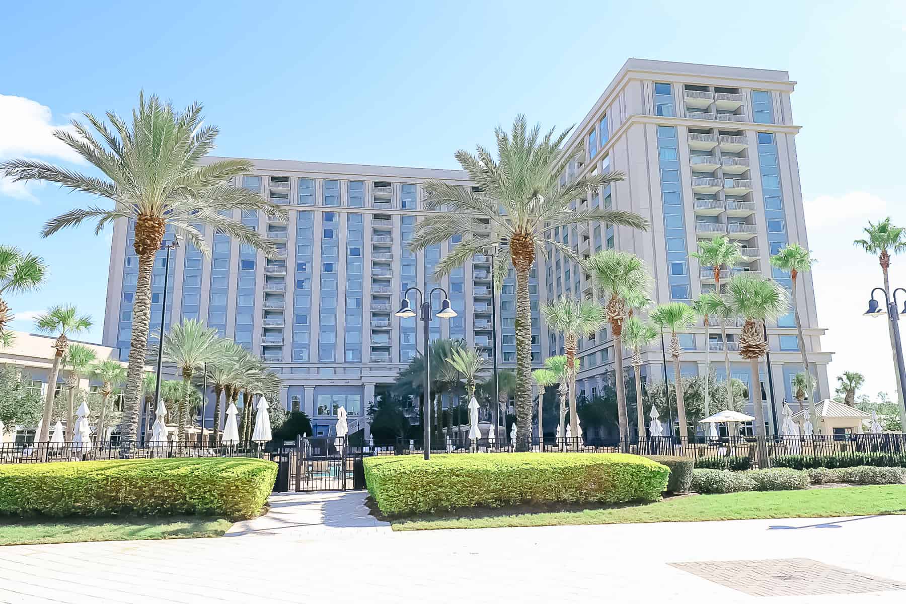 palm trees and landscaping with a resort side view of the Waldorf Astoria Orlando 