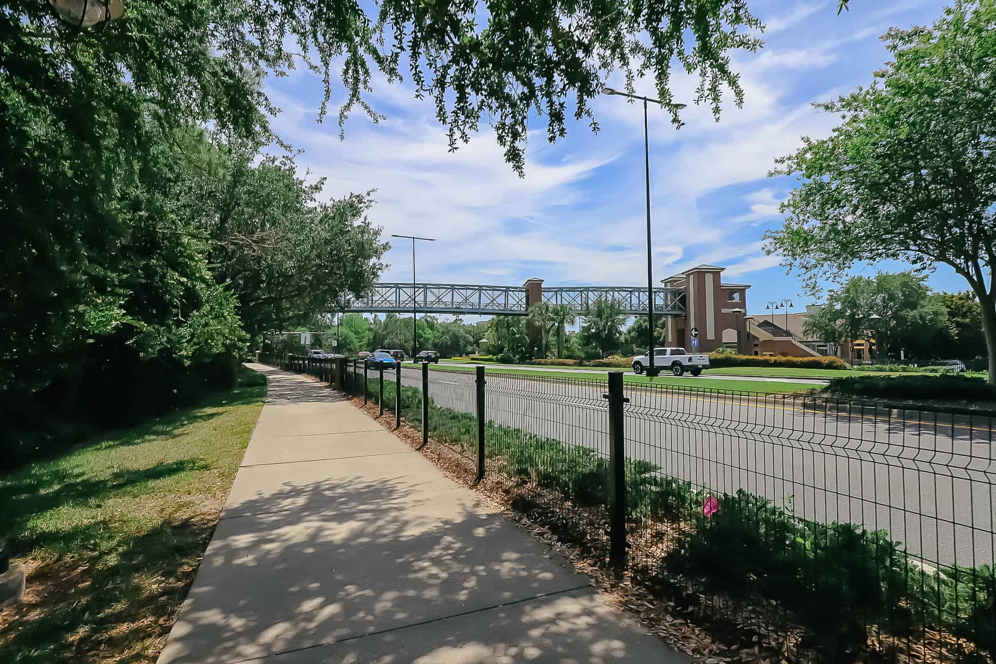 the sidewalk to Disney Springs has a fence as a barrier