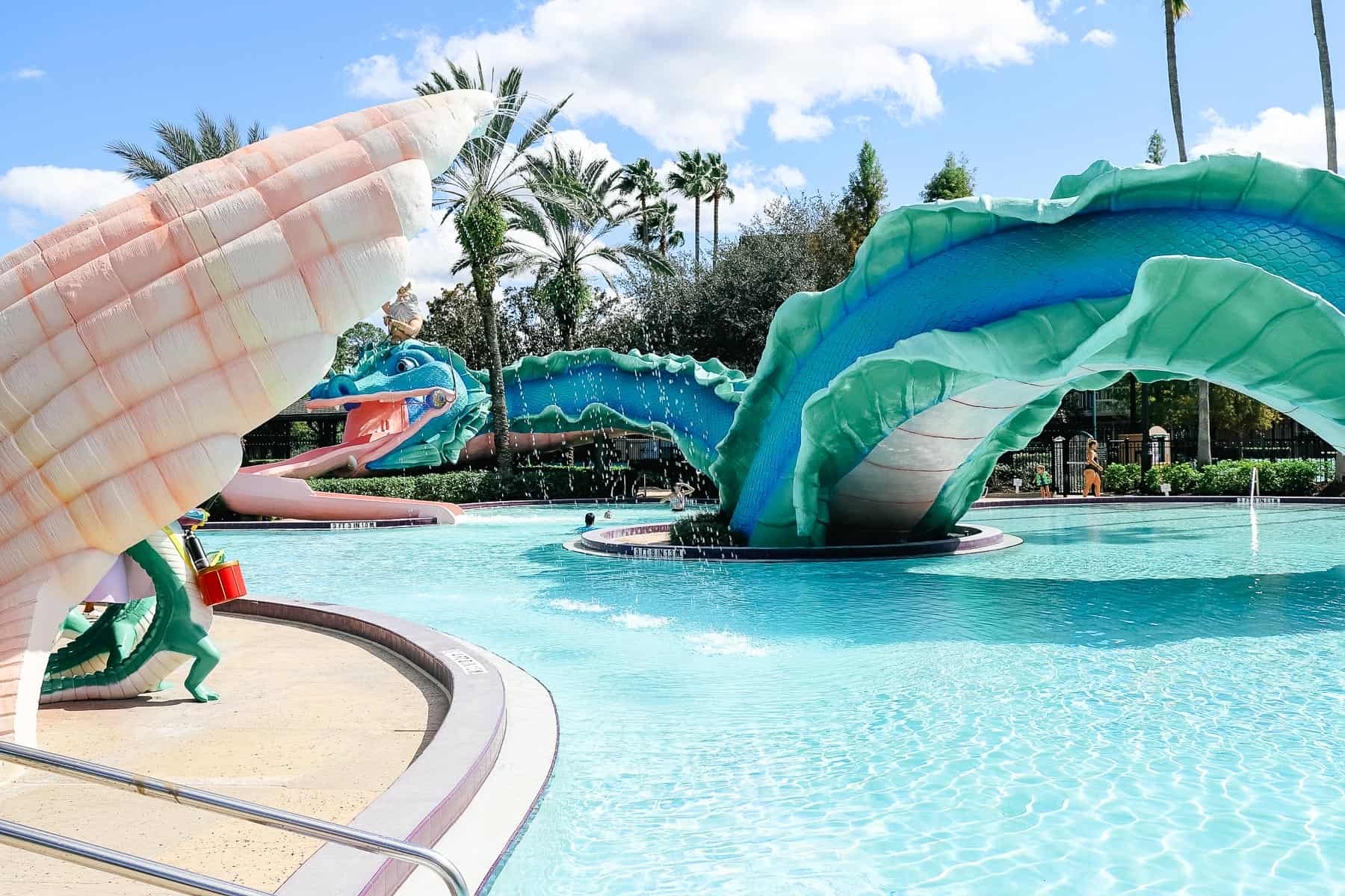 shows the length of the sea serpent extending over the pool with a water feature 