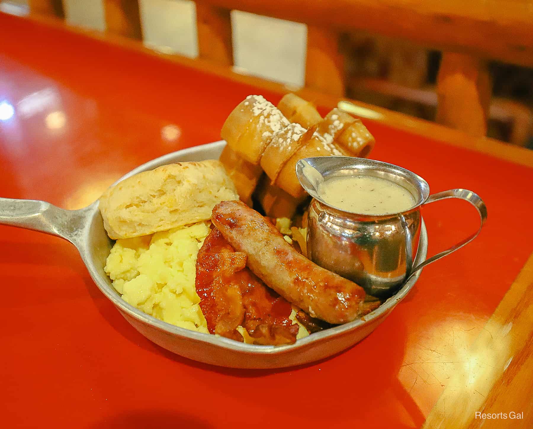 a breakfast skillet from Whispering Canyon Cafe with sausage, bacon, eggs, biscuits, gravy, and Mickey Waffles 