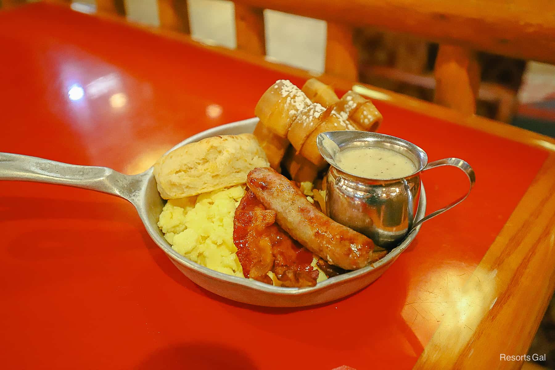 the breakfast skillet is brought out in a silver skillet with a handle packed with food 