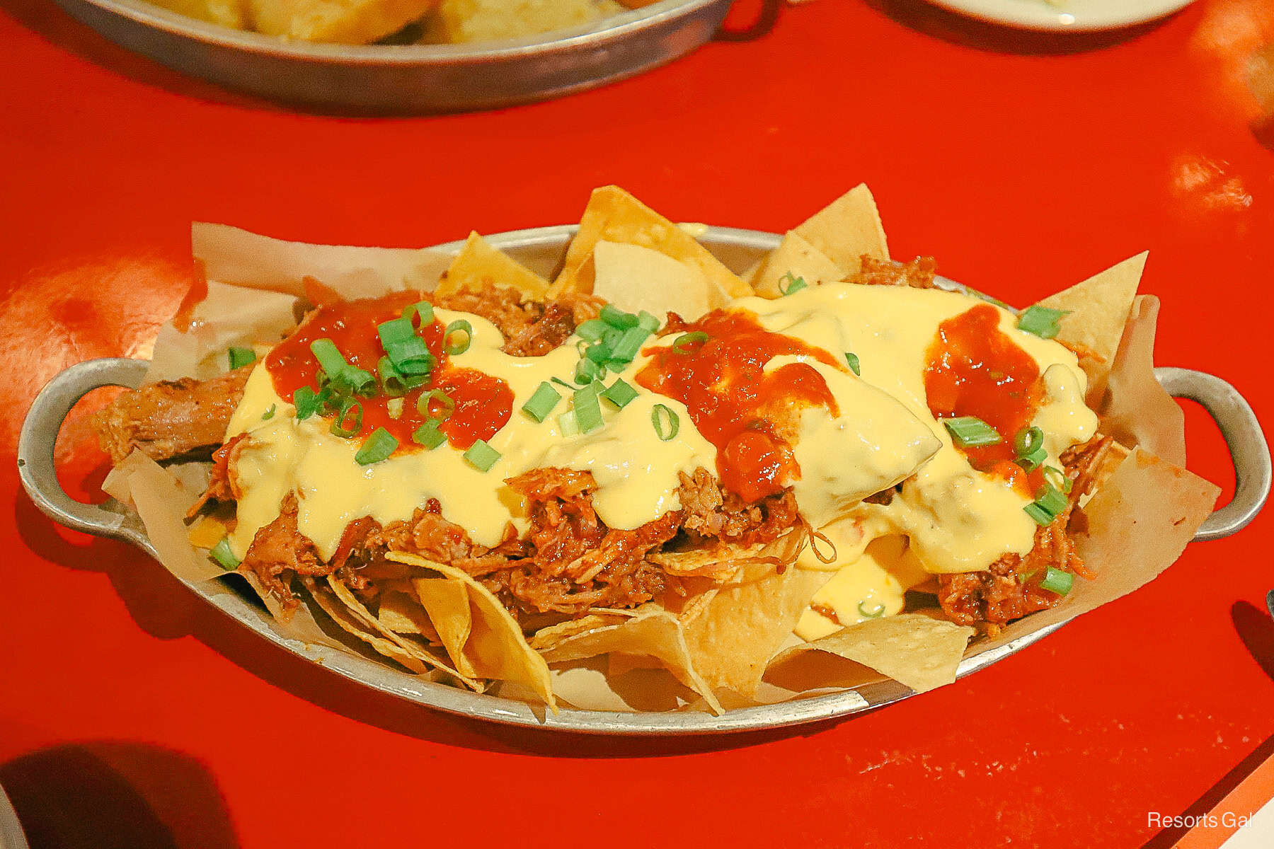 a closeup of the cheese sauce covering the nachos 