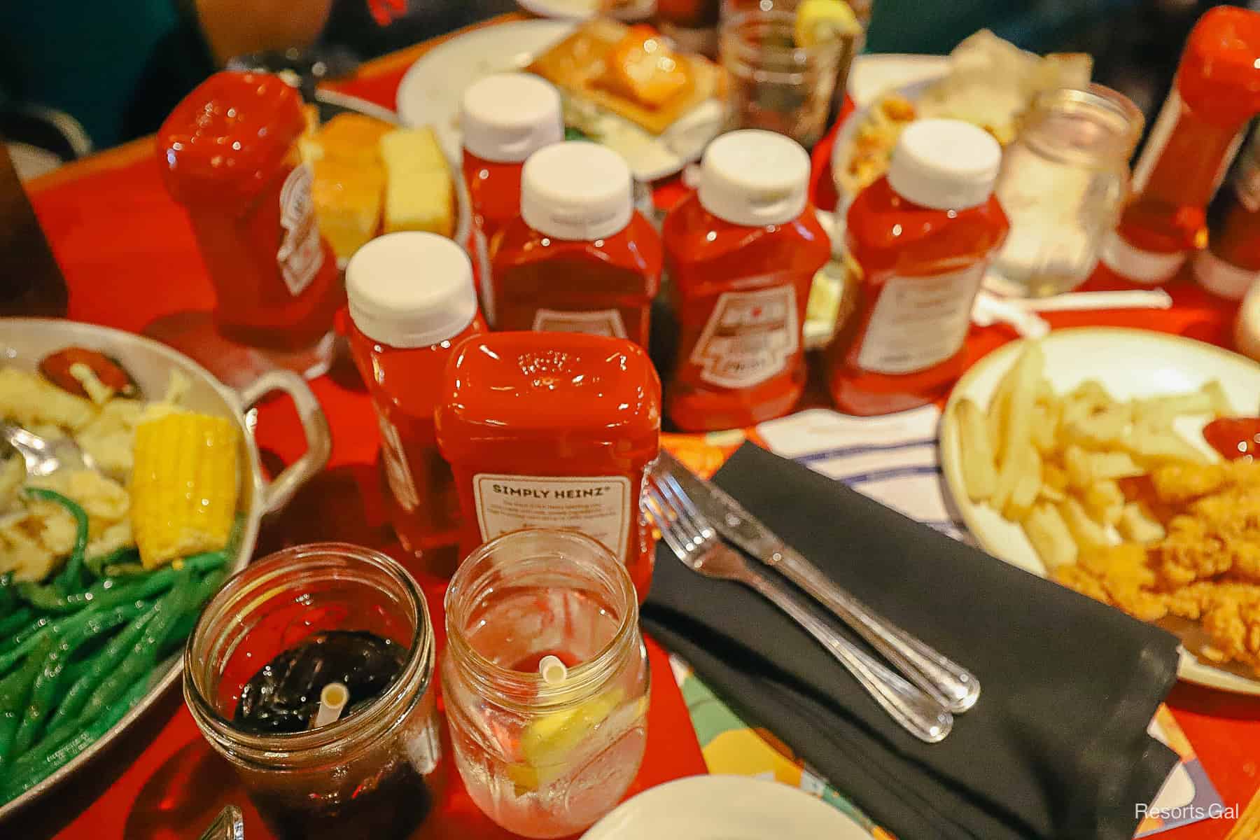 bottles of ketchup all over the dinner table 