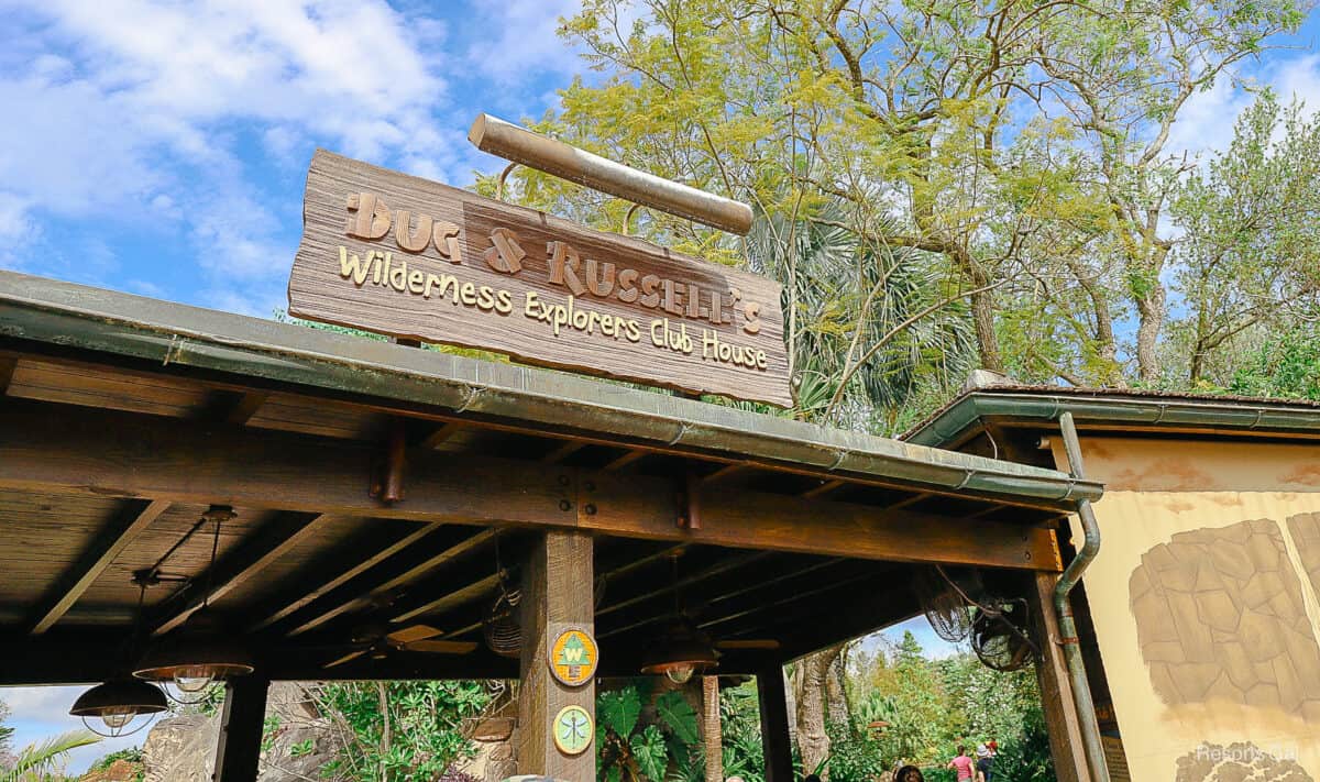 a sign that says Dug & Russell's Wilderness Explorers Club House 