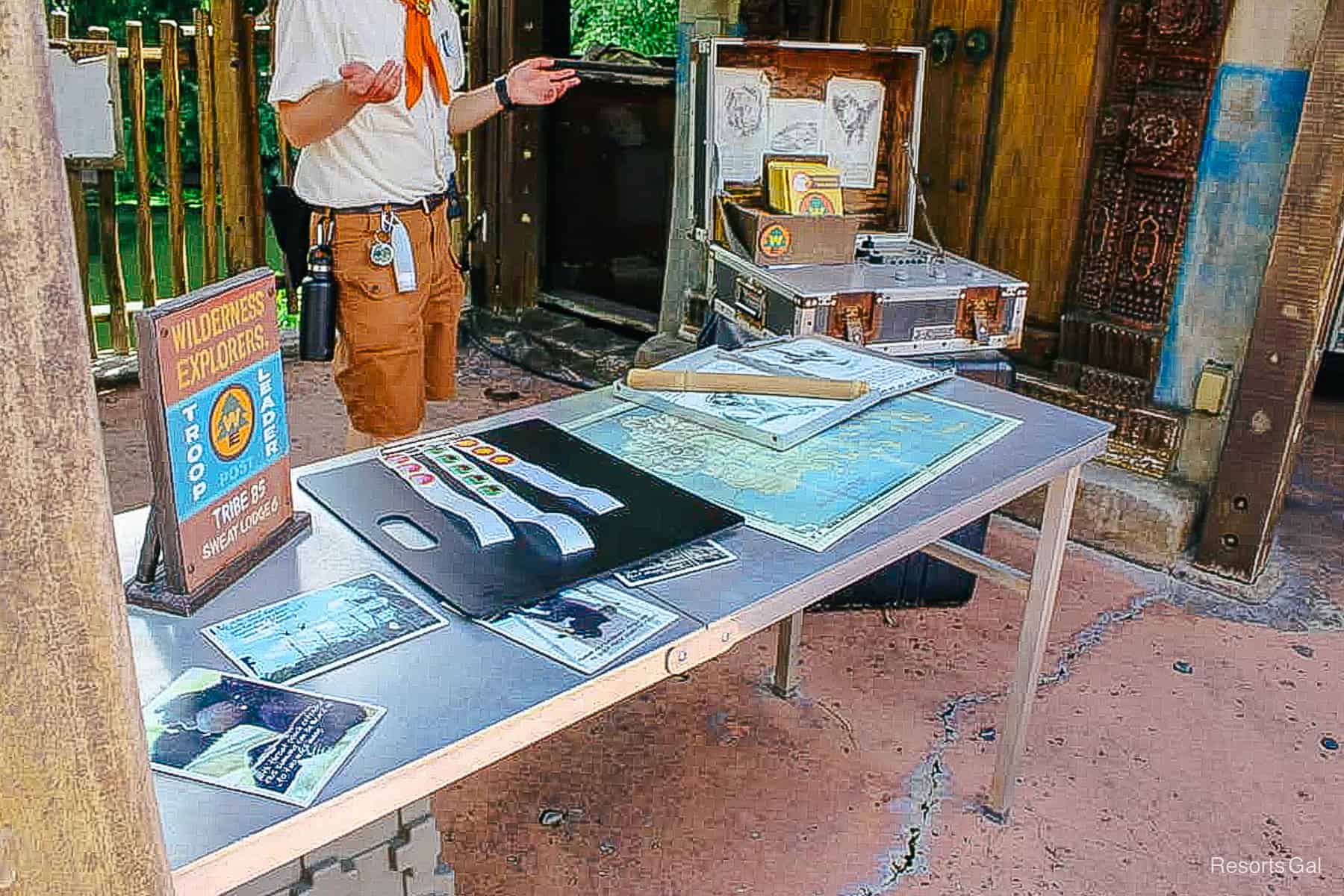 a table with stickers, badges, and maps 