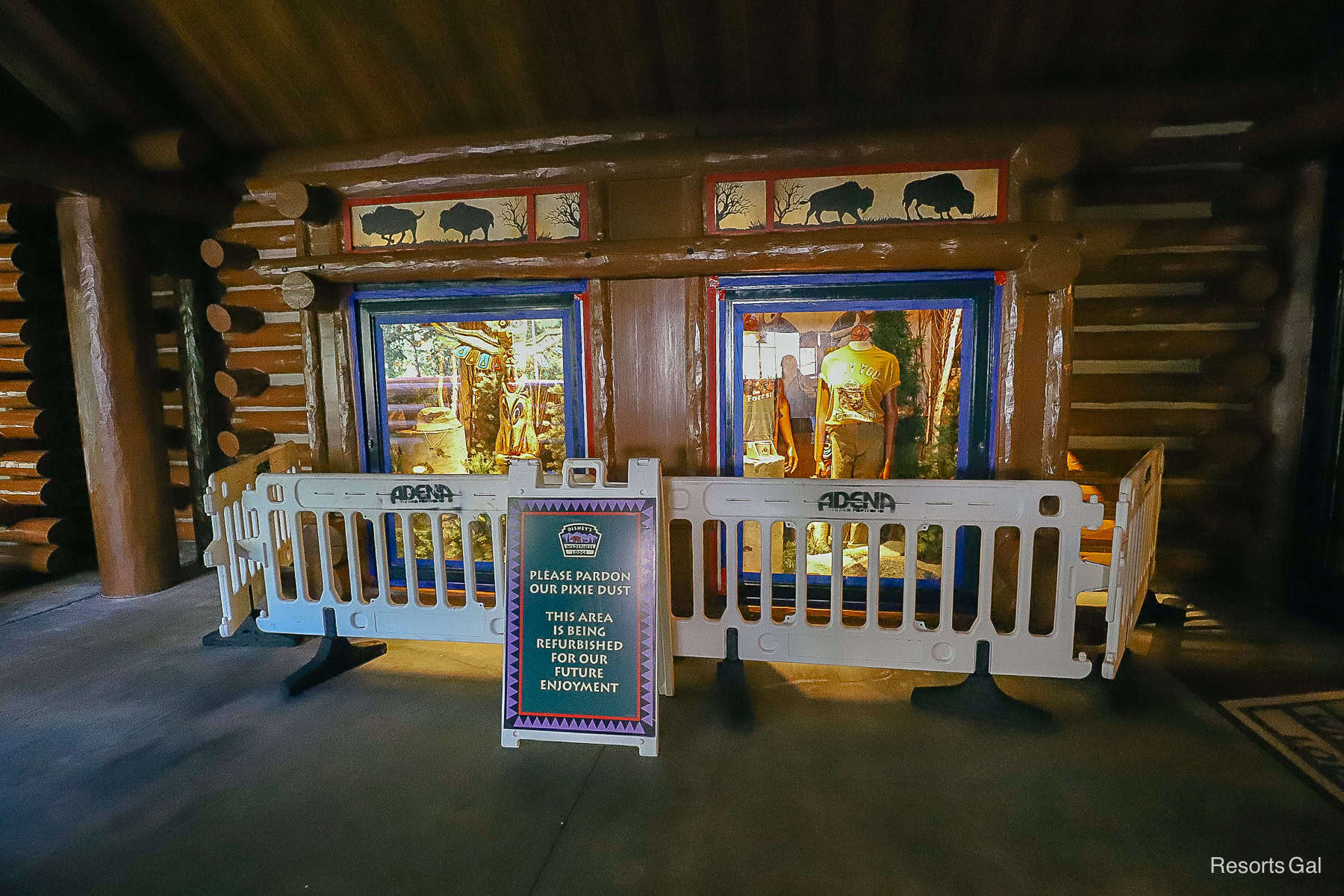 an area being painted with gift shop items displayed in a window