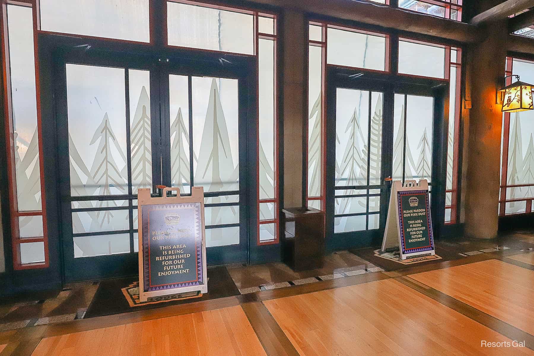 two doors in the Wilderness Lodge lobby blocked off by signs