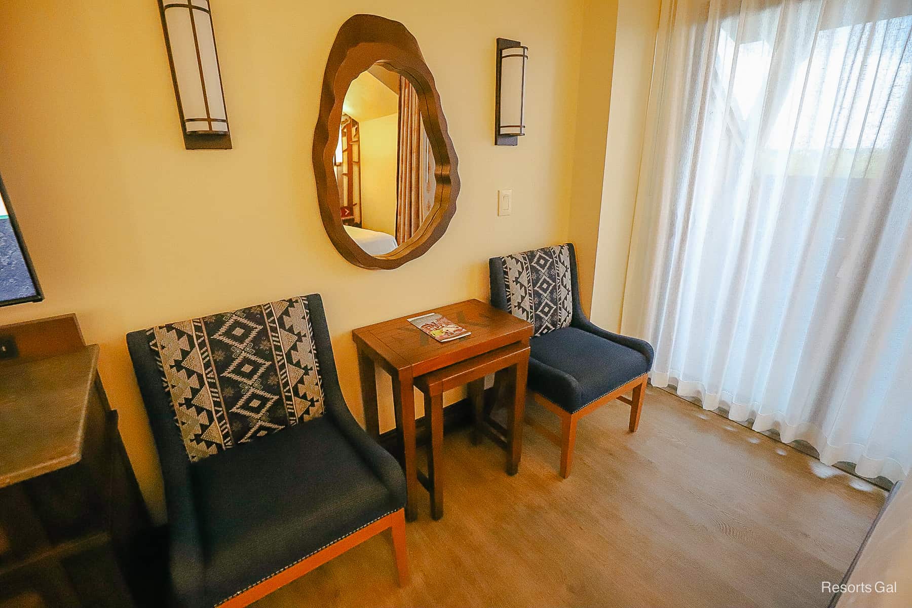 a pair of nesting tables with two chairs in the room at Disney's Wilderness Lodge 