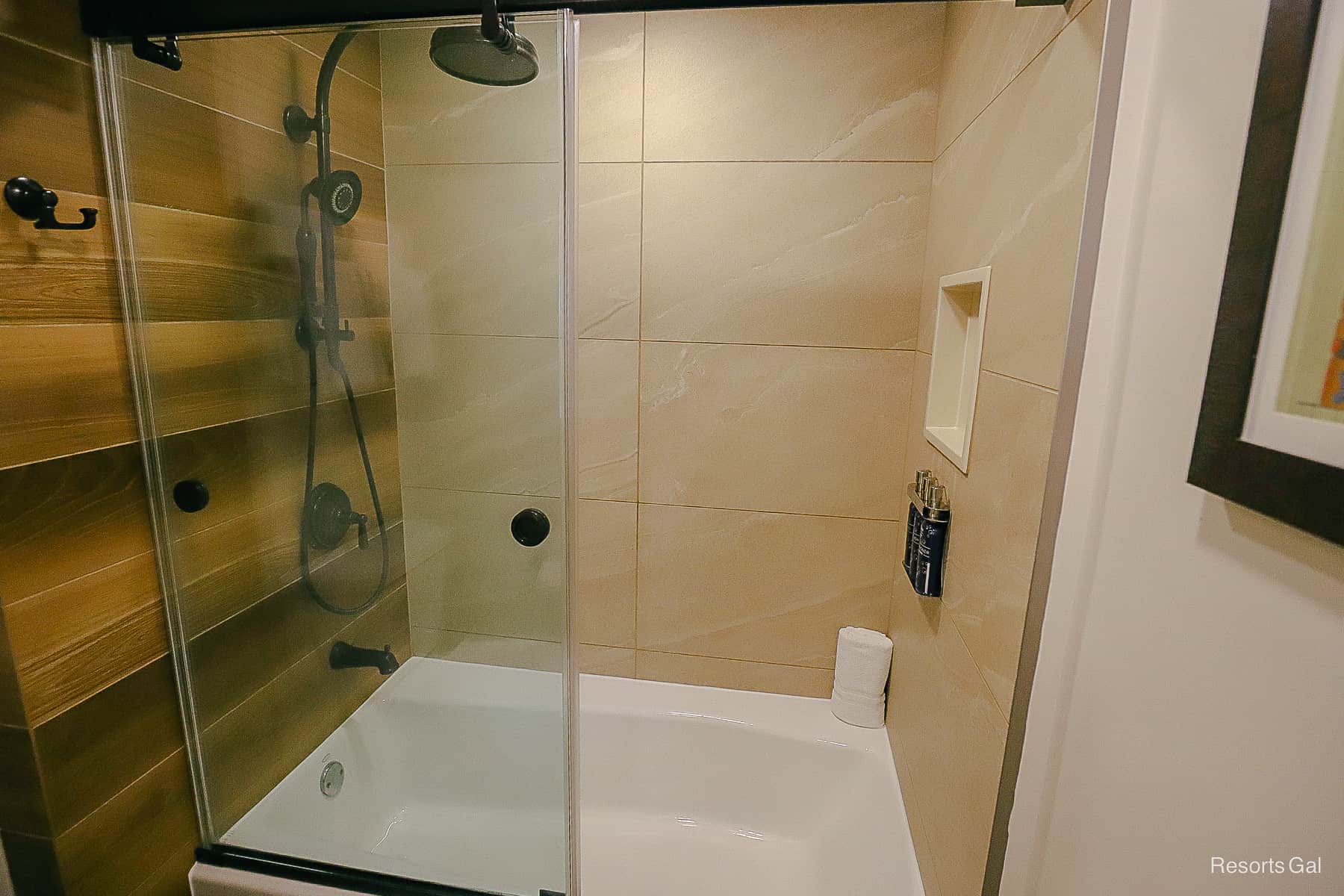 a bath with a tub and shower combination in a room at Disney's Wilderness Lodge 