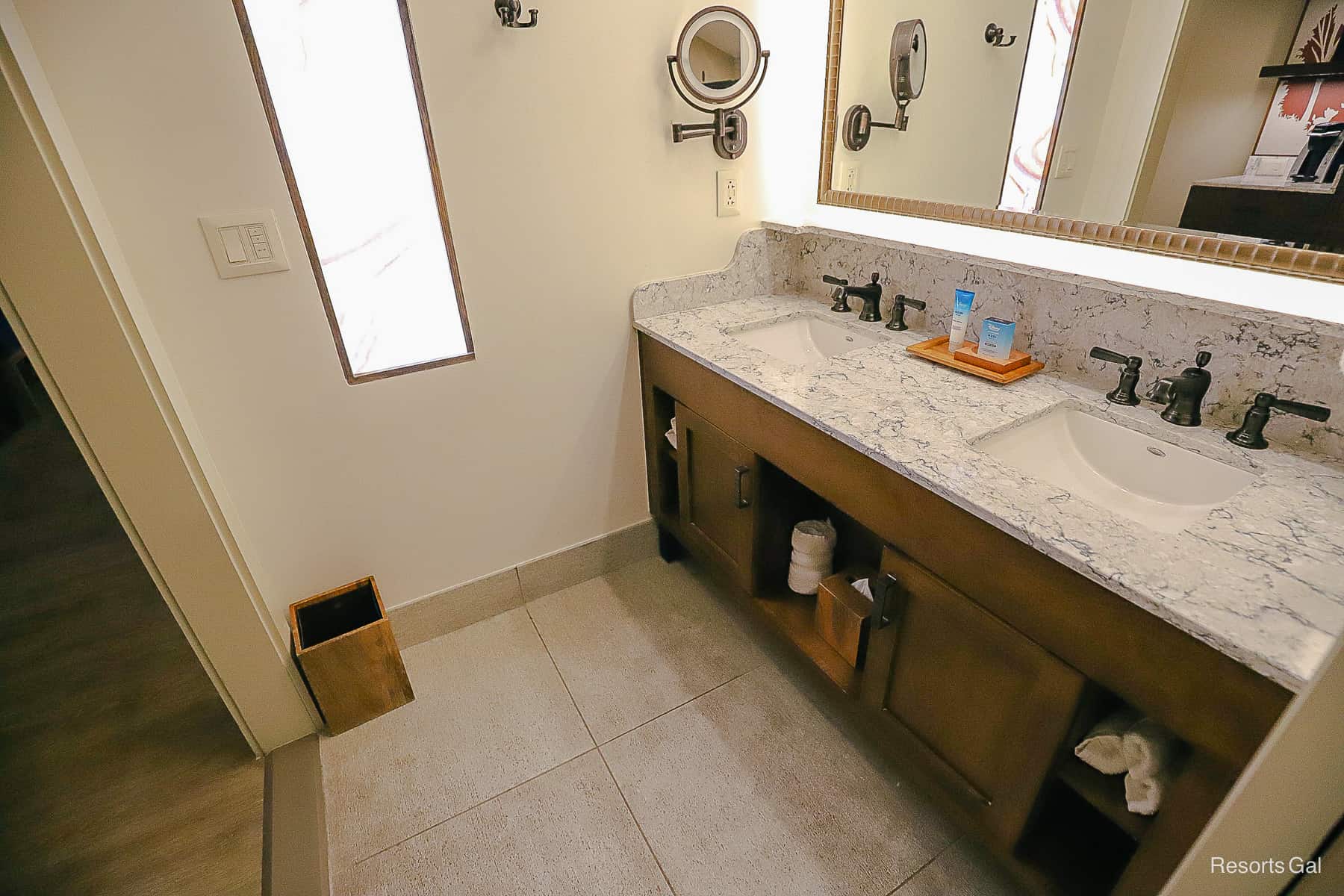 the bathroom area with two sinks and a vanity 