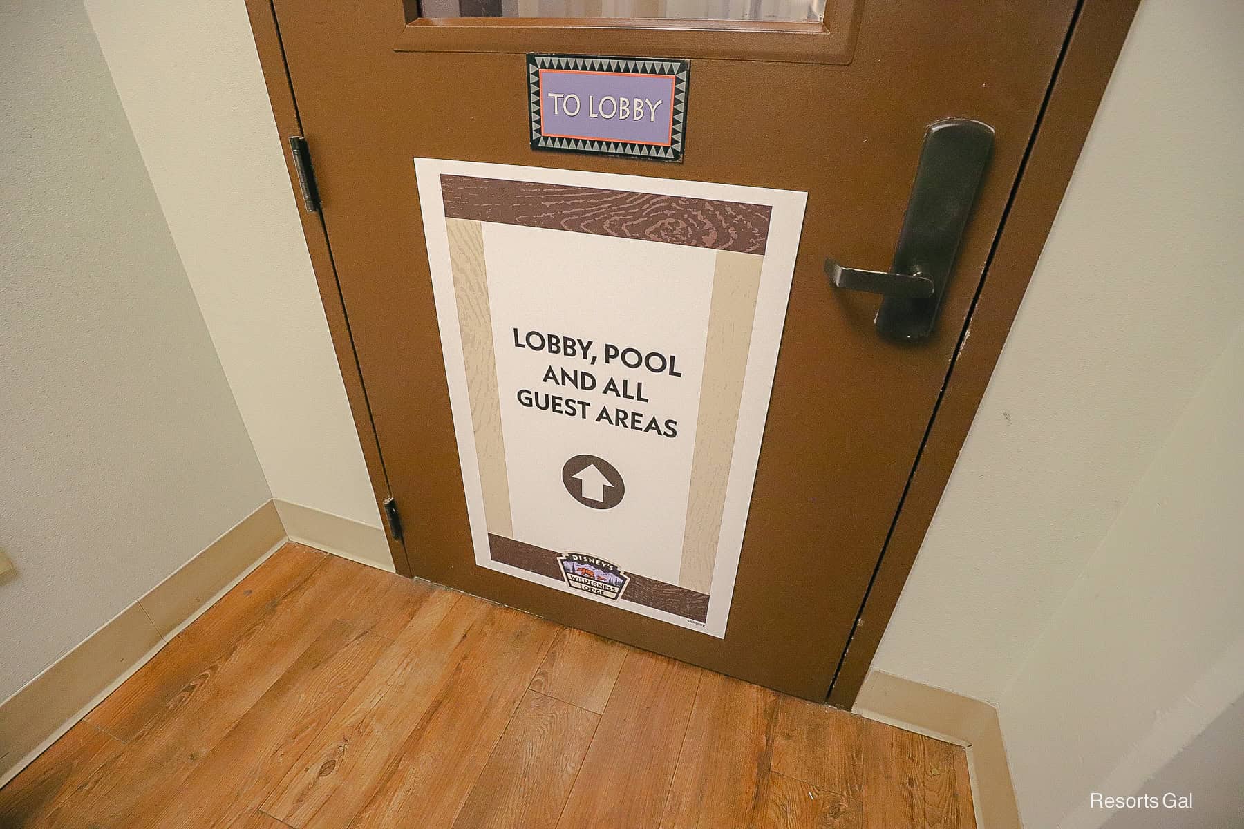a sign on a door that points guests to the lobby, pool, and all guest areas