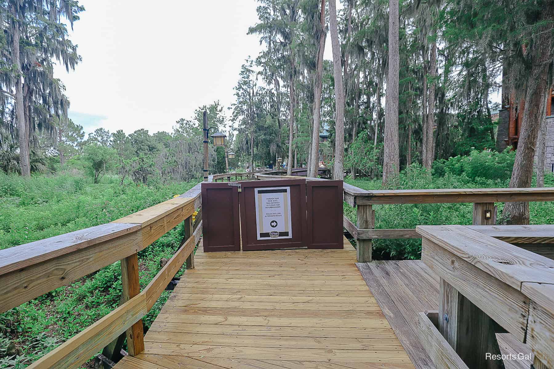 a fence blocking entrance to the unfinished boardwalk