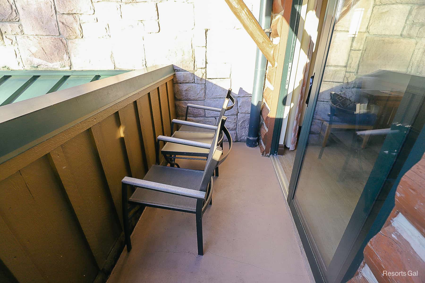 a balcony with two chairs 