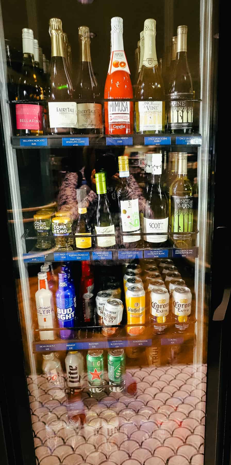 various kinds of wine in a refrigerated case 