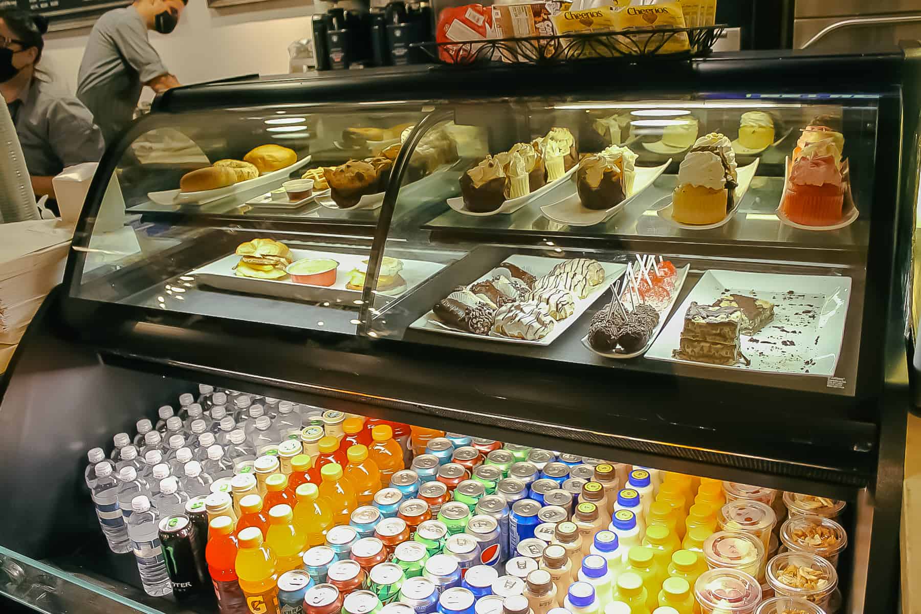 dessert case stocked full of cupcakes and other treats 