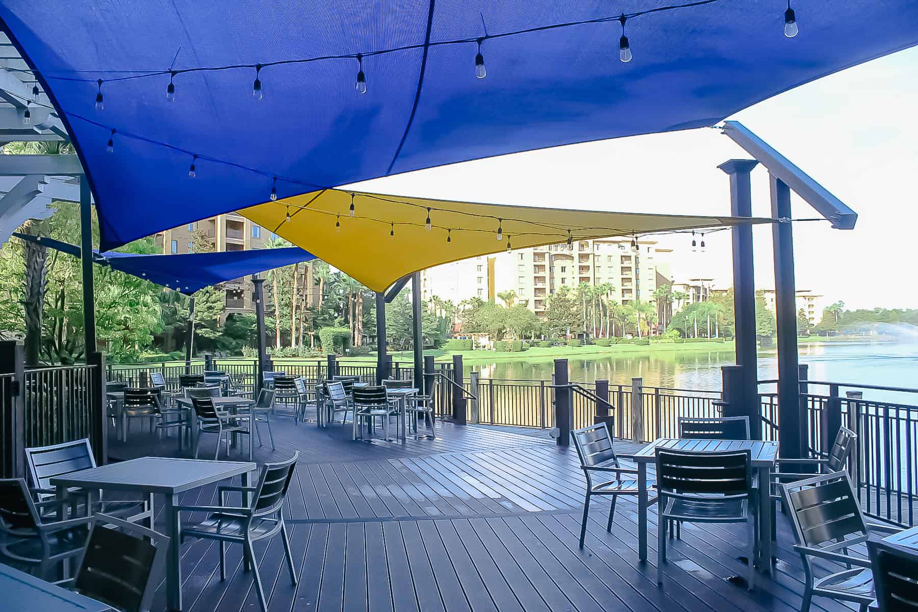 a deck with some shade looking out to the lake 