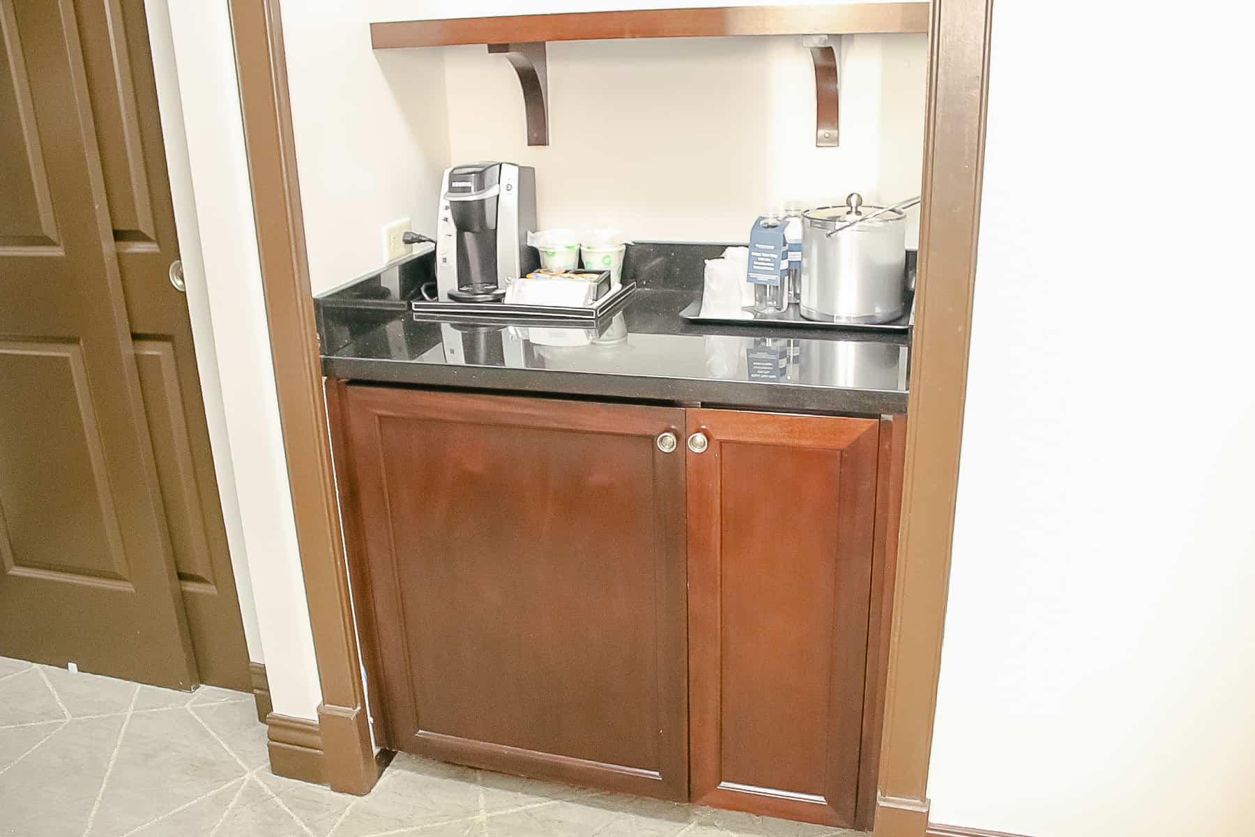 a cabinet with room for drinks and coffee 
