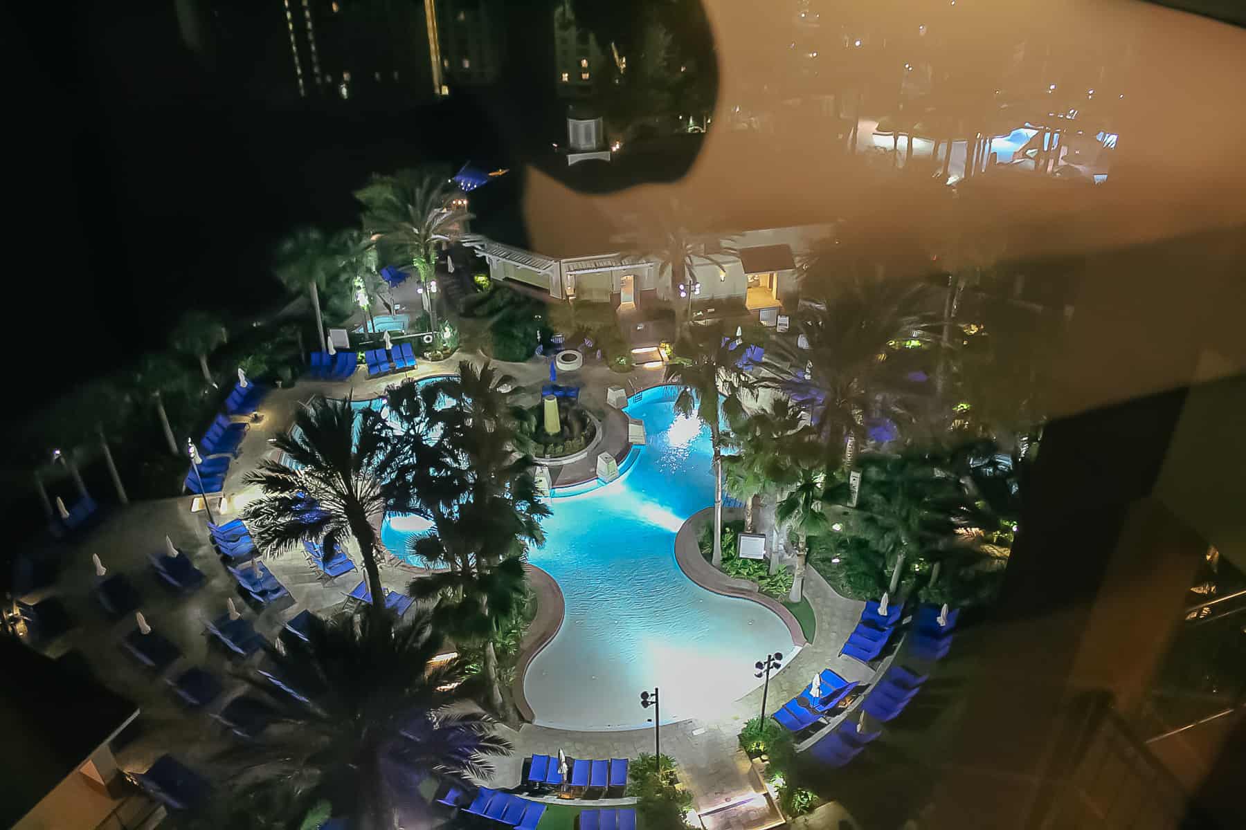 room with a view of the pool at night 
