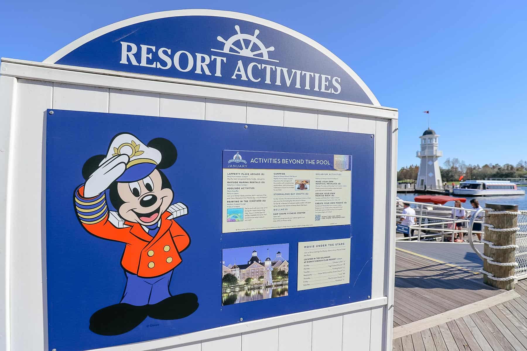 a sign with Captain Mickey that lists the Movie Under the Stars schedule at Yacht Club
